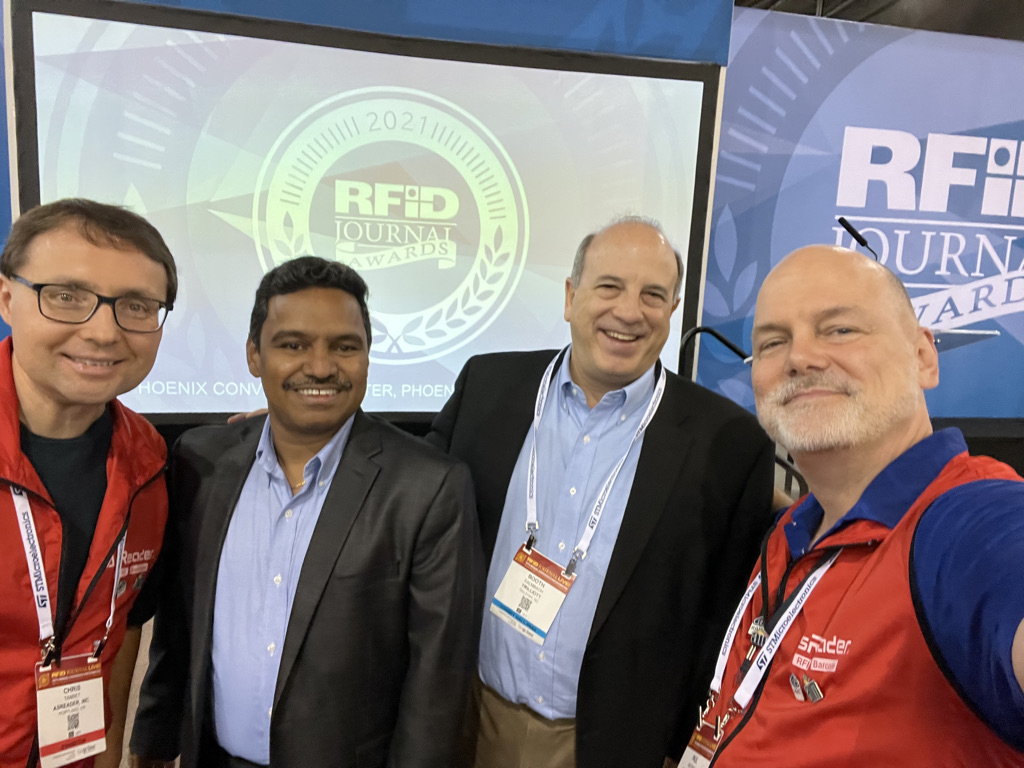 4 men at RFID booth receive award